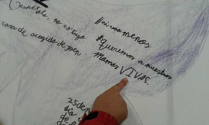 "Queremos a nuestras mamás vivas", escrito con el corazón de un niña.