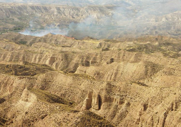 Imagen del fuego, al fondo, junto a los badlands del desierto de los Coloraos de Gorafe.
