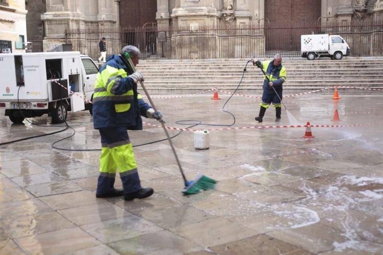 Operarios de Inagra limpiando las pintadas en el pavimento del entorno de la Catedral.