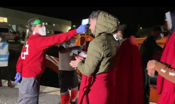 Una voluntaria de Cruz Roja toma la temperatura a los migrantes al desembarcar. Una voluntaria de Cruz Roja toma la temperatura a los migrantes al desembarcar.