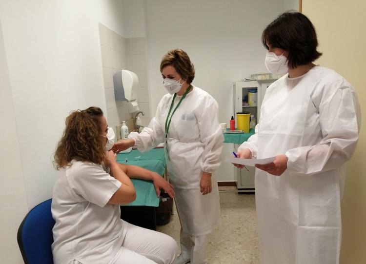En la imagen, junto a la profesional vacunada, Berta Gorlat y Silvia Valenzuela, profesionales también del centro, que han sido formadas para la vacunación. Eva, técnico de Rayos en el Hospital Virgen de las Nieves, al recibir la vacuna.
