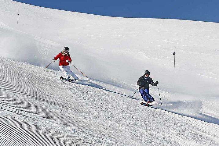 Esquiadores en las pistas habilitadas para esquiar al amanecer. 