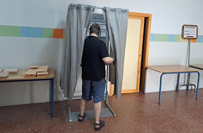 Un elector, en una cabina electoral.