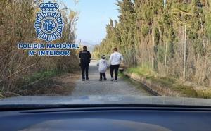 Un agente acompaña al menor tras ser localizado. 