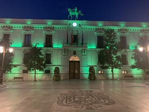Fachada del Consistorio iluminada de verde.