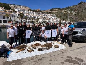 Los buzos voluntarios que han participado en la recogida de basuras en la Punta de la Mona, en Granada, junto a los residuos retirados del fondo marino.