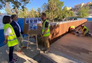 Operarios dan los últimos retoques a las maderas del puente. 