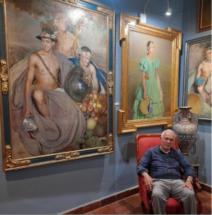 Juan Manuel Segura espera sentado en la sala dedicada a retratos de Gabriel Morcillo.