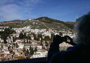 Una turista toma una fotografía del Albaicín.